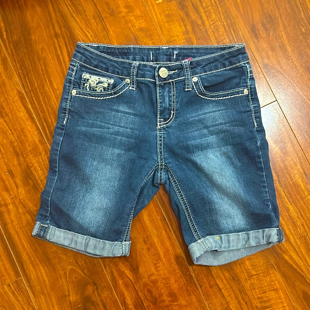 Jean shorts… mid thigh length. Cute wing detail in the back.